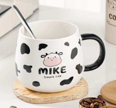 ceramic coffee mug with lid and spoon