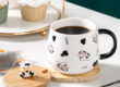 ceramic coffee mug with lid and spoon
